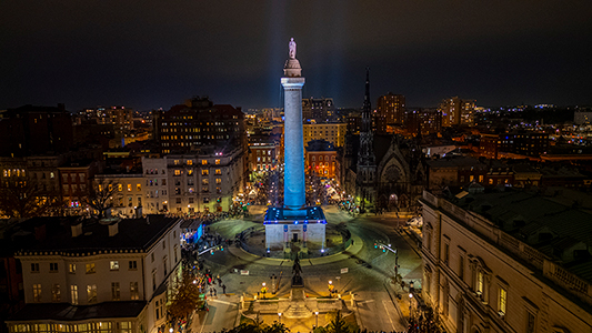 Illuminated monument in urban nightscape.